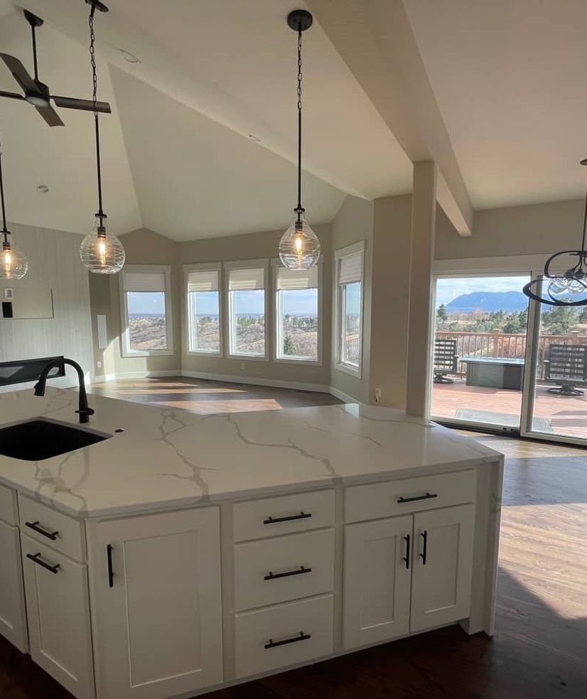 White kitchen with island and pendant lighting